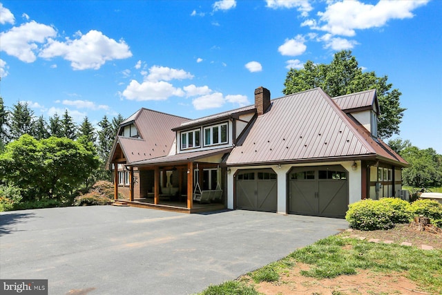 615 Beinhower Rd, Etters, PA 17319 - view of front of home featuring driveway, a metal roof, a garage, and a chimney
