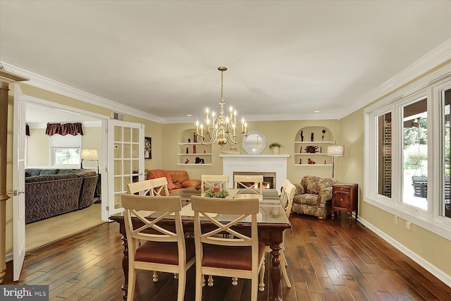 615 Beinhower Rd, Etters, PA 17319 - dining space with dark wood-style floors, a lit fireplace, crown molding, a chandelier, and built in shelves