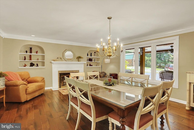 615 Beinhower Rd, Etters, PA 17319 - dining space featuring dark wood-style flooring, a chandelier, ornamental molding, a tile fireplace, and built in shelves
