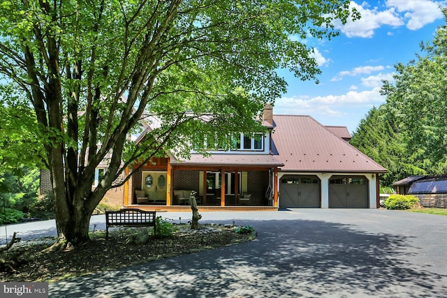 615 Beinhower Rd, Etters, PA 17319 - view of front of house with covered porch, an attached garage, asphalt driveway, brick siding, and a chimney