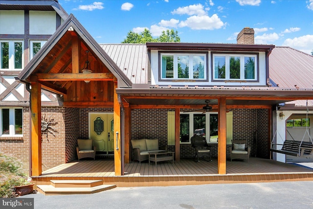 615 Beinhower Rd, Etters, PA 17319 - back of property featuring a ceiling fan, a deck, a metal roof, a chimney, and an outdoor living space