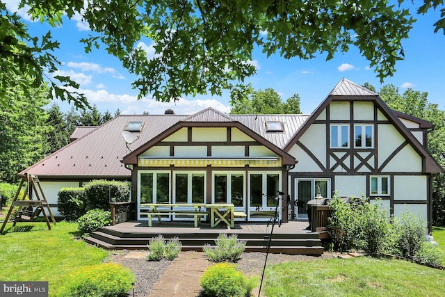 615 Beinhower Rd, Etters, PA 17319 - rear view of property with a yard, stucco siding, a wooden deck, and a metal roof