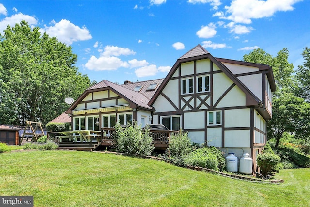 615 Beinhower Rd, Etters, PA 17319 - back of house featuring stucco siding, a wooden deck, a yard, and a metal roof