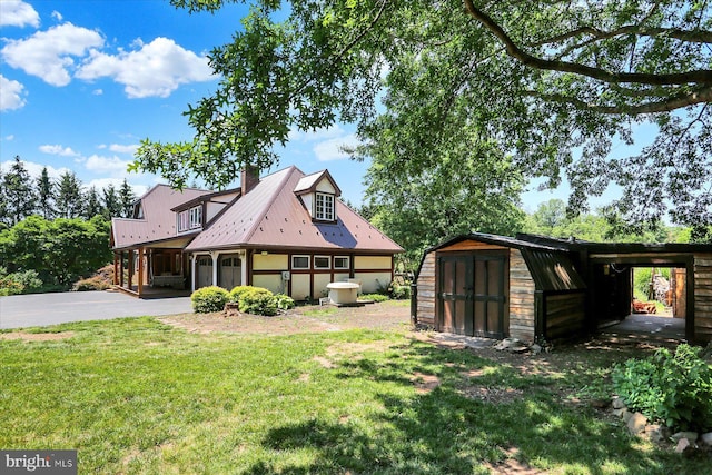 615 Beinhower Rd, Etters, PA 17319 - view of front of home featuring a storage shed, a front lawn, a metal roof, and a chimney