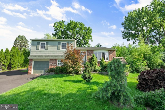643 Comly Ave, Langhorne, PA 19047 - view of front of property featuring brick siding, a garage, driveway, and a front yard