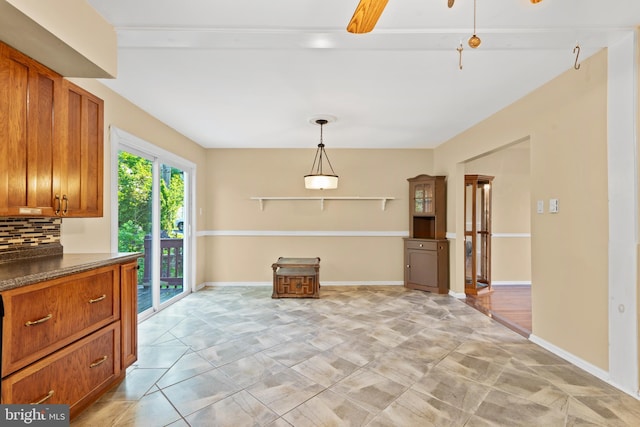 643 Comly Ave, Langhorne, PA 19047 - kitchen featuring brown cabinets, dark countertops, tasteful backsplash, and decorative light fixtures