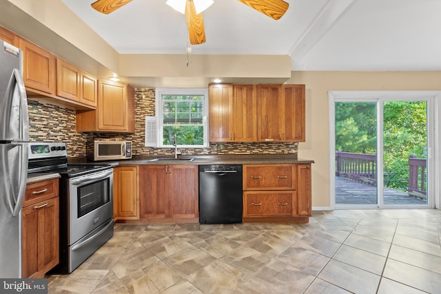 643 Comly Ave, Langhorne, PA 19047 - kitchen with appliances with stainless steel finishes, decorative backsplash, dark countertops, a ceiling fan, and brown cabinets
