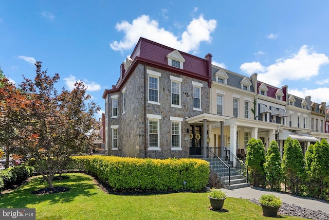 1125 K St NE, Washington, DC 20002 - view of property featuring stone siding, mansard roof, a front lawn, a high end roof, and a chimney