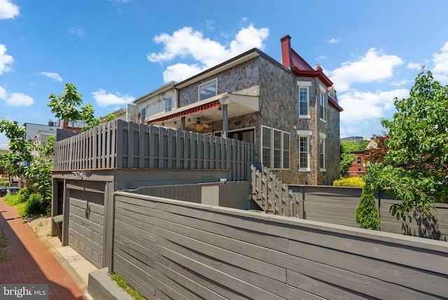 1125 K St NE, Washington, DC 20002 - view of side of home featuring stone siding and stairway