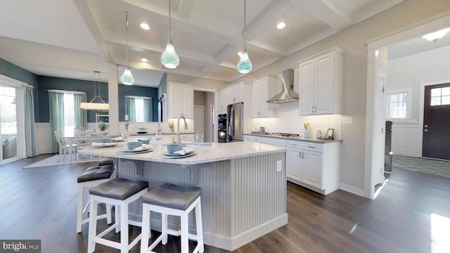 05A Weatherstone Ln, Felton, DE 19943 - kitchen with wall chimney range hood, freestanding refrigerator, coffered ceiling, dark wood-style flooring, and white cabinetry