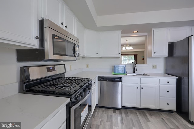 1206 Fredrick Blvd, Reading, PA 19605 - kitchen with stainless steel appliances, a chandelier, light countertops, white cabinets, and recessed lighting