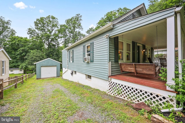 148 Reservoir Rd, Hopewell, NJ 08525 - view of property exterior with an outdoor structure, driveway, a detached garage, covered porch, and cooling unit