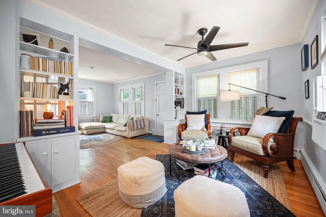 148 Reservoir Rd, Hopewell, NJ 08525 - living room featuring a baseboard radiator, ornamental molding, a ceiling fan, wood finished floors, and built in shelves