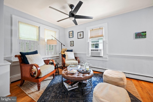148 Reservoir Rd, Hopewell, NJ 08525 - sitting room with a baseboard radiator, wood finished floors, ceiling fan, and ornamental molding