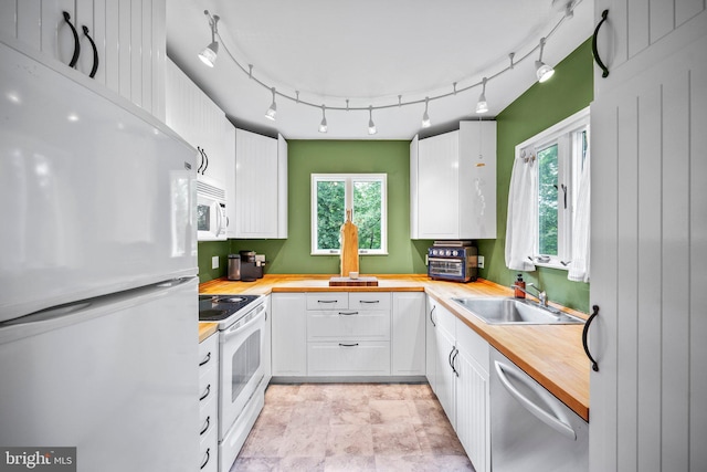 148 Reservoir Rd, Hopewell, NJ 08525 - kitchen with white appliances, butcher block counters, white cabinetry, and plenty of natural light