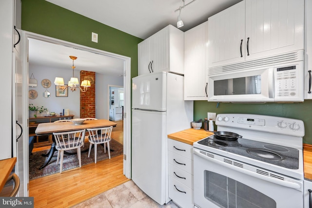 148 Reservoir Rd, Hopewell, NJ 08525 - kitchen with white appliances, a chandelier, white cabinetry, pendant lighting, and butcher block counters