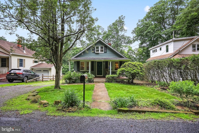 148 Reservoir Rd, Hopewell, NJ 08525 - bungalow-style house with a porch, driveway, and a front lawn