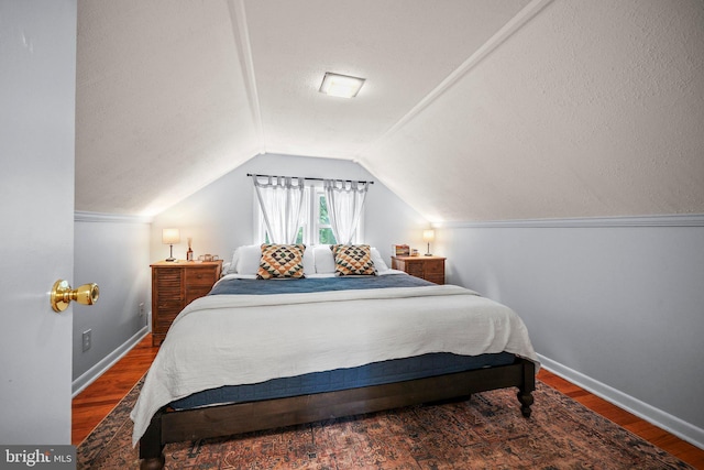 148 Reservoir Rd, Hopewell, NJ 08525 - bedroom featuring wood finished floors, vaulted ceiling, and a textured ceiling