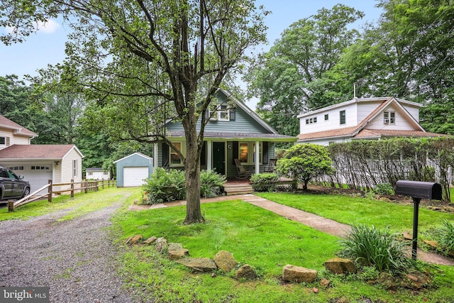 148 Reservoir Rd, Hopewell, NJ 08525 - view of front facade with an outdoor structure, covered porch, a garage, and gravel driveway