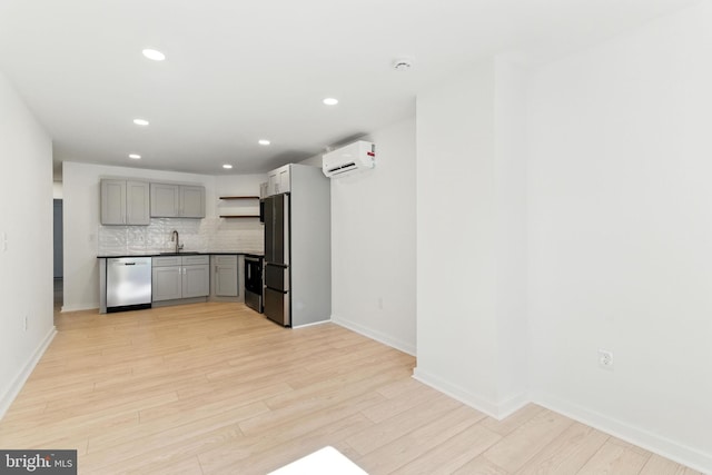 1948 S 23rd St, Philadelphia, PA 19145 - kitchen featuring appliances with stainless steel finishes, an AC wall unit, gray cabinetry, open shelves, and backsplash