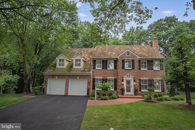 15508 Summer Grove Ct, Gaithersburg, MD 20878 - colonial home with asphalt driveway, a front yard, brick siding, and a chimney