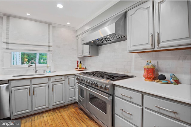 15508 Summer Grove Ct, Gaithersburg, MD 20878 - kitchen with stainless steel appliances, gray cabinets, wall chimney exhaust hood, light wood-type flooring, and light countertops