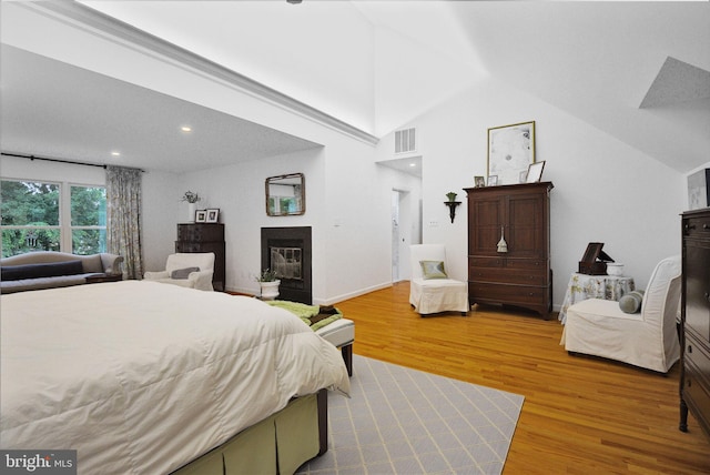 15508 Summer Grove Ct, Gaithersburg, MD 20878 - bedroom featuring a glass covered fireplace, wood finished floors, lofted ceiling, and recessed lighting