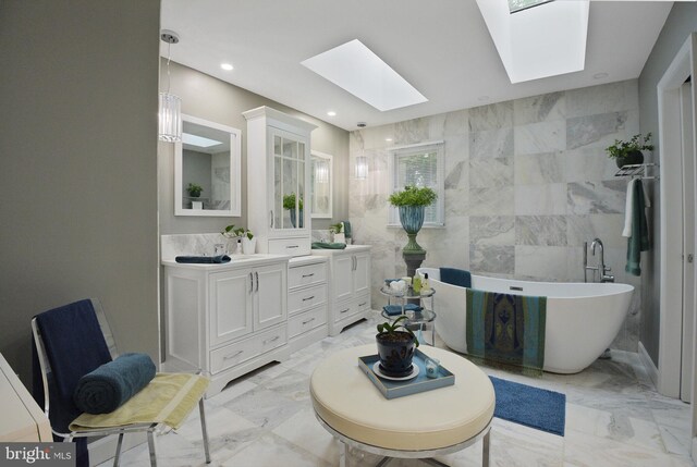 15508 Summer Grove Ct, Gaithersburg, MD 20878 - bathroom with a skylight, double vanity, a freestanding tub, marble tiled flooring, and recessed lighting