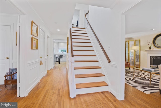15508 Summer Grove Ct, Gaithersburg, MD 20878 - staircase featuring wood-type flooring, crown molding, a high end fireplace, and recessed lighting