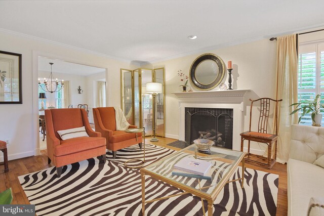 15508 Summer Grove Ct, Gaithersburg, MD 20878 - living room featuring wood finished floors, ornamental molding, a fireplace with flush hearth, and a chandelier