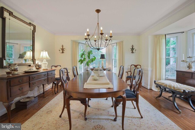 15508 Summer Grove Ct, Gaithersburg, MD 20878 - dining area with healthy amount of natural light, a chandelier, wood finished floors, and crown molding
