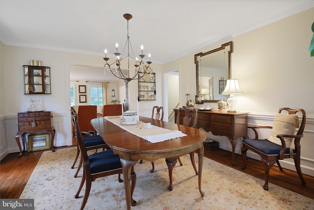 15508 Summer Grove Ct, Gaithersburg, MD 20878 - dining area featuring wood-type flooring, a chandelier, ornamental molding, a wainscoted wall, and a decorative wall