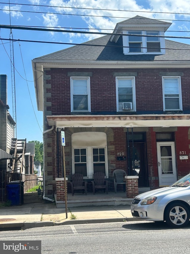 829 W Washington St, Hagerstown, MD 21740 - view of front facade with brick siding, a porch, and roof with shingles