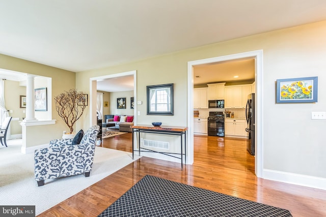 231 Caleb Dr, West Chester, PA 19382 - living area with light wood-style flooring and decorative columns