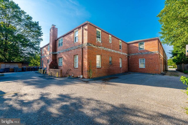 410 Main St Unit 9, Laurel, MD 20707 - view of side of property featuring brick siding and a chimney