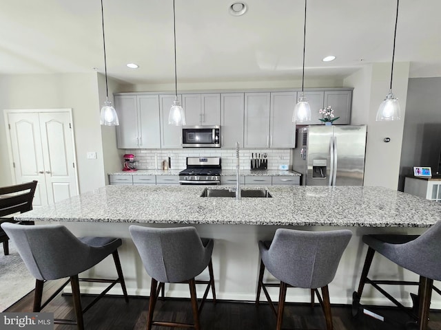 921 Sandy Run Rd, Baltimore, MD 21220 - kitchen with appliances with stainless steel finishes, tasteful backsplash, a spacious island, a breakfast bar area, and pendant lighting