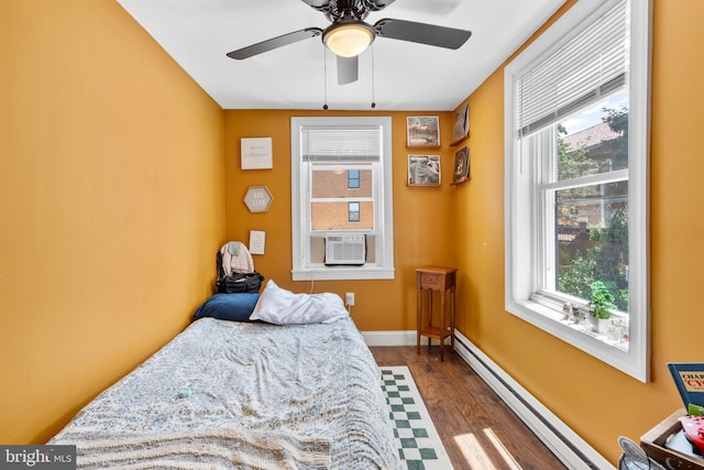 3567 Joyce St, Philadelphia, PA 19134 - bedroom with dark wood finished floors, multiple windows, a baseboard radiator, and cooling unit