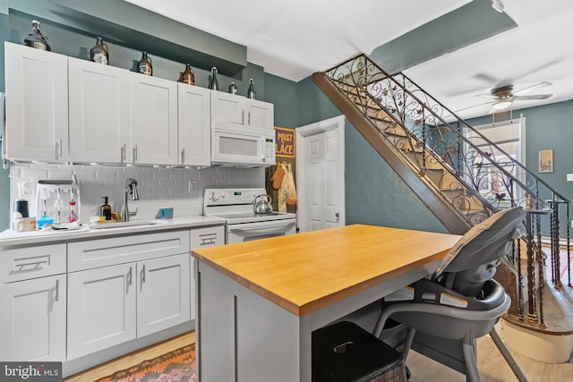 3567 Joyce St, Philadelphia, PA 19134 - kitchen featuring white appliances, backsplash, a ceiling fan, butcher block countertops, and white cabinetry