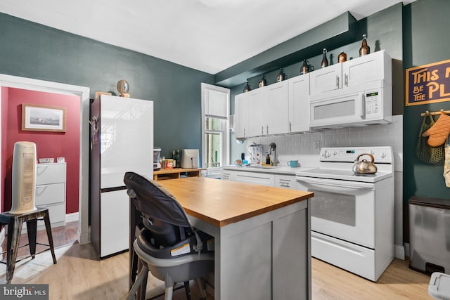 3567 Joyce St, Philadelphia, PA 19134 - kitchen with white appliances, butcher block counters, white cabinetry, light wood-type flooring, and tasteful backsplash
