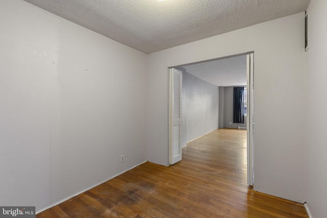 1101 Saint Paul St Unit 603, Baltimore, MD 21202 - empty room featuring wood finished floors and a textured ceiling