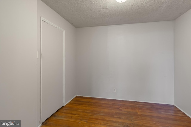1101 Saint Paul St Unit 603, Baltimore, MD 21202 - empty room with wood finished floors and a textured ceiling