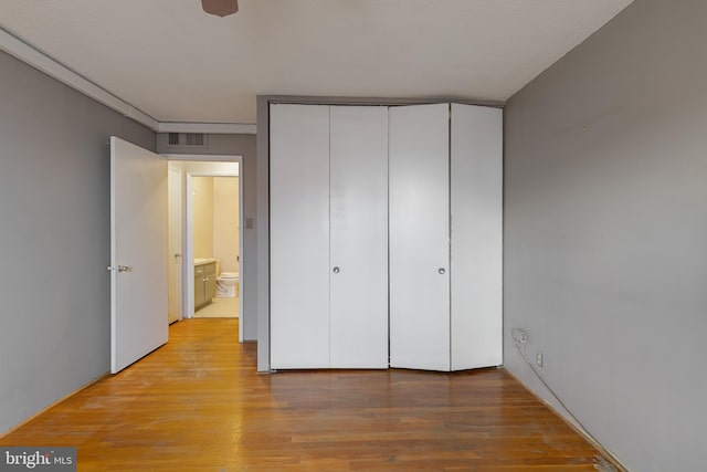 1101 Saint Paul St Unit 603, Baltimore, MD 21202 - unfurnished bedroom featuring light wood-style flooring and a closet