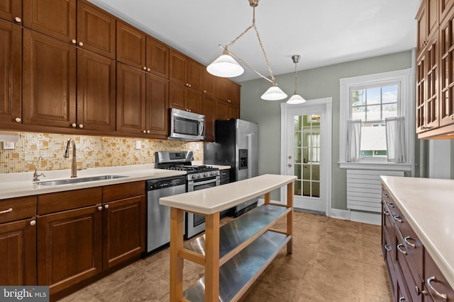 101 Cliff Ter, Wyncote, PA 19095 - kitchen featuring appliances with stainless steel finishes, light countertops, tasteful backsplash, pendant lighting, and glass insert cabinets