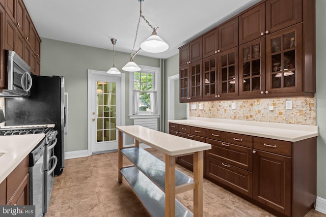 101 Cliff Ter, Wyncote, PA 19095 - kitchen with stainless steel appliances, glass insert cabinets, decorative backsplash, and light countertops