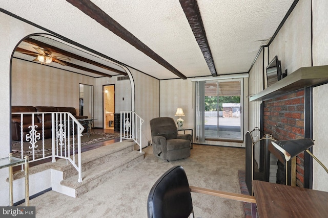 21 Hemmings Way, Lawnside, NJ 08045 - carpeted living room with a textured ceiling, arched walkways, ceiling fan, wallpapered walls, and beamed ceiling