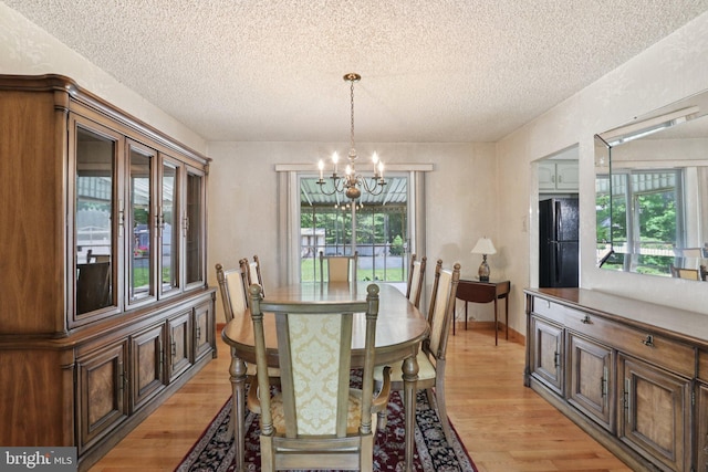 21 Hemmings Way, Lawnside, NJ 08045 - dining room featuring a chandelier, a textured ceiling, light wood-style flooring, and healthy amount of natural light