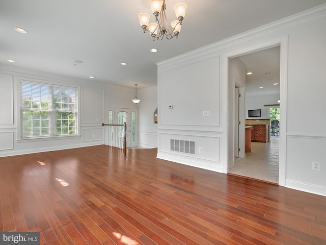 7730 Terraview Ct, Hanover, MD 21076 - unfurnished living room featuring wood finished floors, a chandelier, a decorative wall, ornamental molding, and recessed lighting
