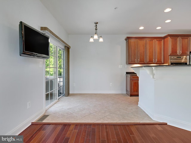 7730 Terraview Ct, Hanover, MD 21076 - kitchen featuring oven, recessed lighting, dark countertops, brown cabinetry, and light wood-style flooring
