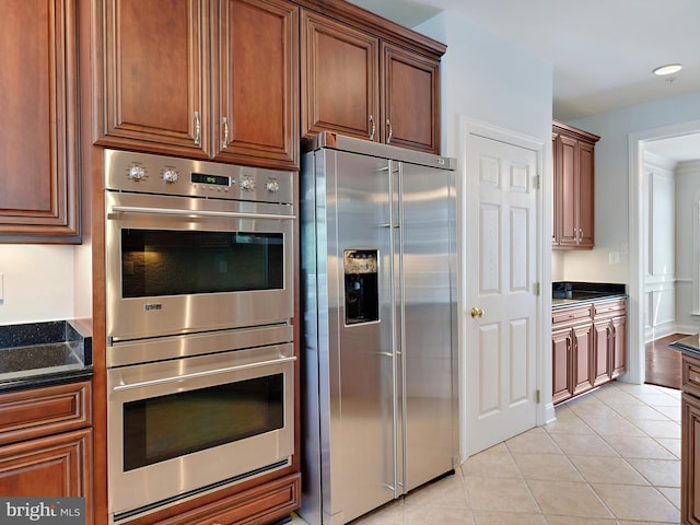 7730 Terraview Ct, Hanover, MD 21076 - kitchen with stainless steel appliances, light tile patterned flooring, and dark stone counters