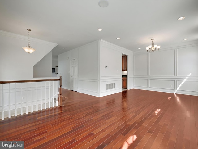 7730 Terraview Ct, Hanover, MD 21076 - unfurnished room with a decorative wall, a chandelier, wood finished floors, crown molding, and recessed lighting